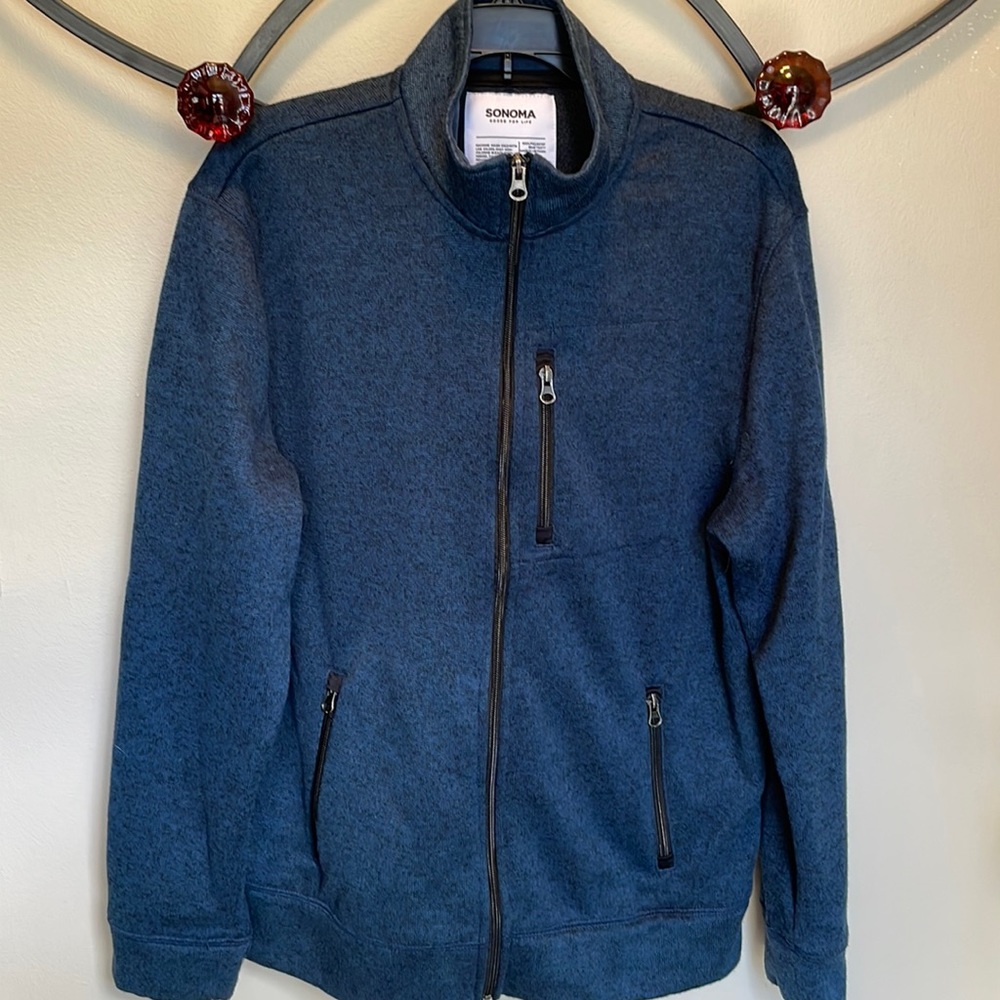 Zipped blue jacket lots of pockets all zipper closings. EUC